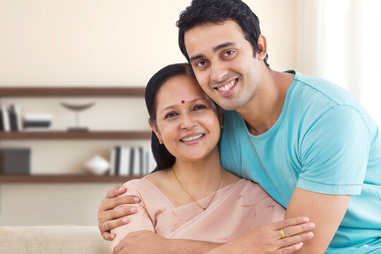 Portrait of young man hugging his mother 