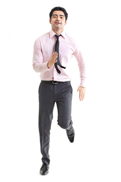 Happy young businessman running over white background 