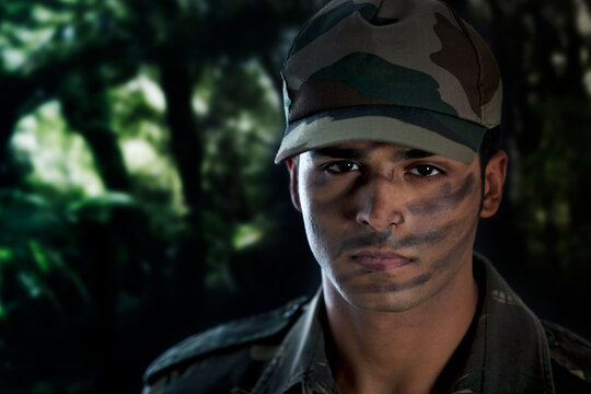 Close-up of serious young man in military uniform 
