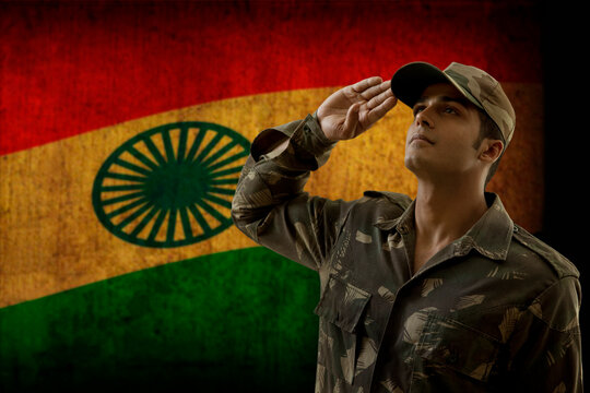 Soldier saluting with Indian flag in background 