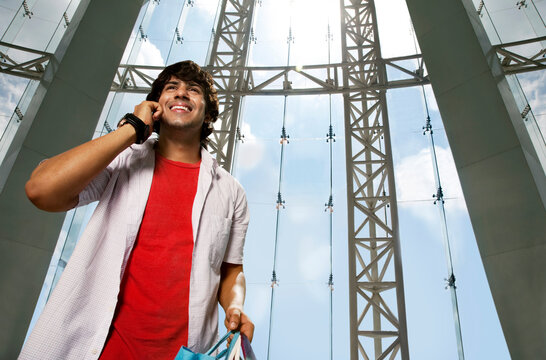 Smiling young man talking on the phone 