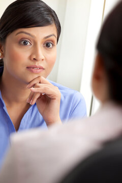 Surprised businesswoman listening to female executive 
