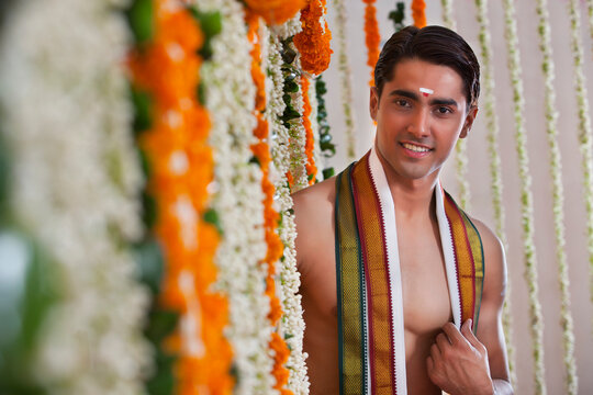 Selective focus of man standing near garland 
