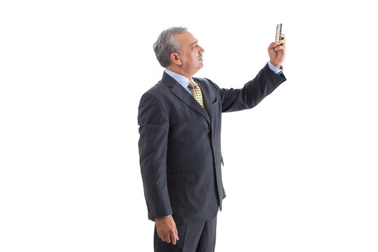 Elegant mature business man sending text message 