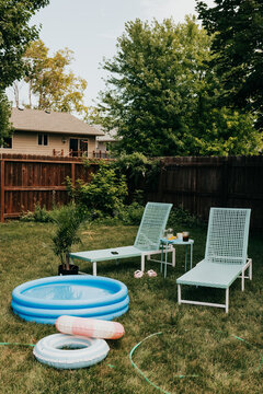 Backyard staycation with an inflatable pool and chairs