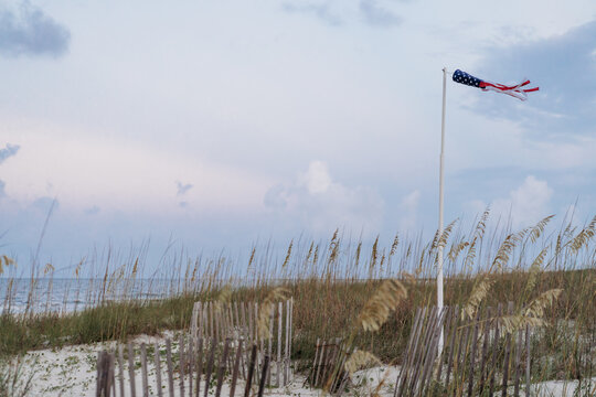 Patriotic windsock flying over coastal dunes