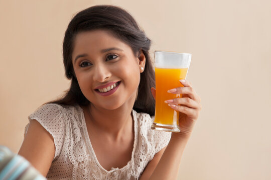 Beautiful young woman having orange juice with man 
