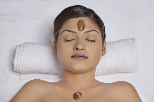 Close-up of young woman getting lastone treatment 