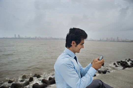 Businessman sending an sms 