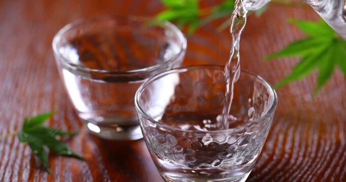 冷酒をガラスのお猪口に注ぐ