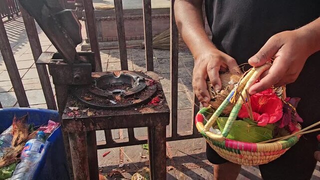 Close-up of a traditional coconut breaking tool used to crack coconuts for religious offerings at Mankamana Temple in Nepal. The scene shows traditional Hindu worship practices and temple rituals.