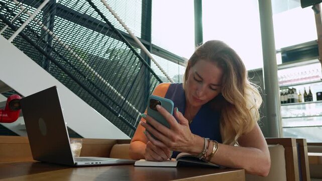 Focused businesswoman working remotely at a cafe
