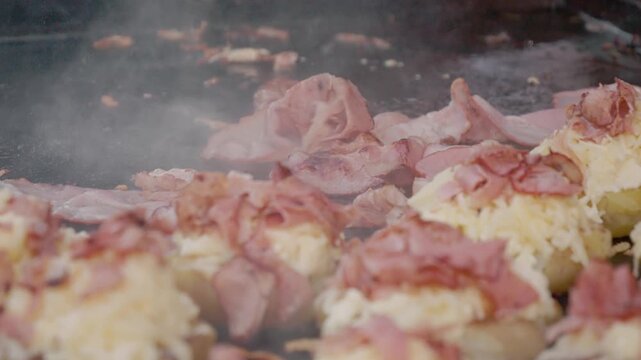 A popular street food dish made of potatoes topped with cheese and ham. It takes place at a festival in Bukovina, filled with food and local culture.