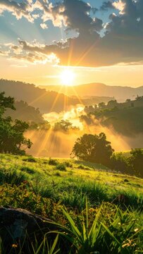 Golden sun rays pierce through misty valleys at sunrise.
