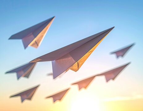 A group of paper airplanes flying towards the sun.
