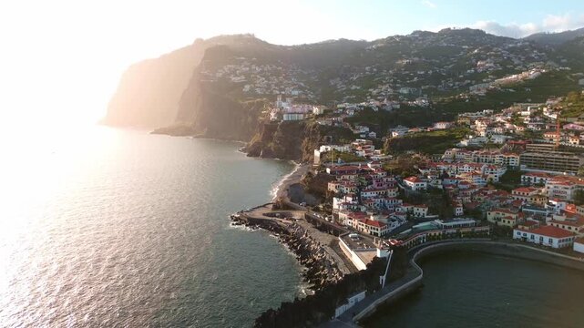 sunset aerial view of C&acirc;mara de Lobos fishing village on Madeira Island, Portugal