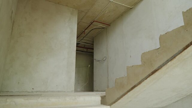 Construction progress of a modern concrete building. Reinforced concrete structure under development, showing structural framework and ongoing construction work.