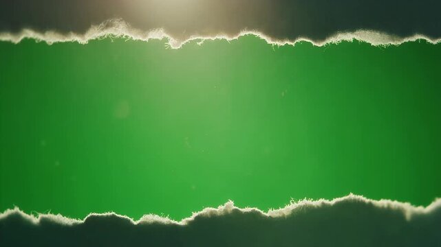 A horizontal rip in dark material reveals a bright green background.