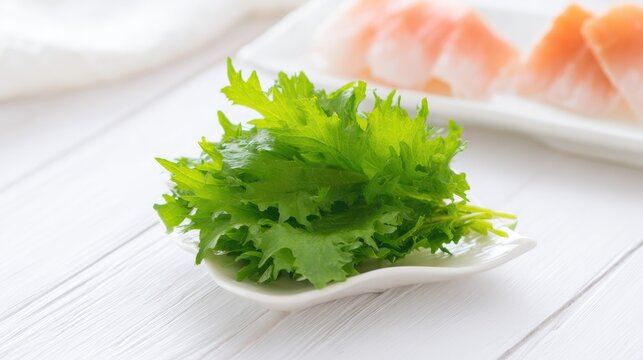 mizuna. Fresh green mizuna garnish on white plate beside sashimi, clean culinary presentation. lifestyle magazines, social media lookbooks, designed for lifestyle magazines and social media content.