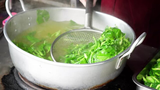 4K Video of Transferring Blanched Chinese Kale from Hot Water to Food Tray