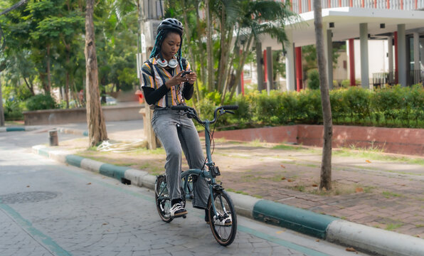 Commuting to work with bicycle. Young business person cycling and riding electric scooter to office in downtown district. Modern diversity people use eco transportation in city. Sustainable lifestyle.