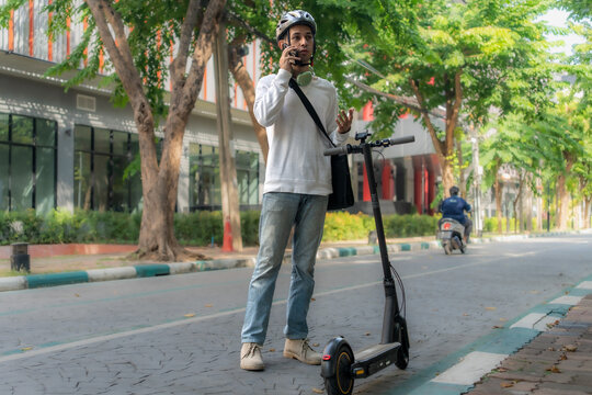 Commuting to work with bicycle. Young business person cycling and riding electric scooter to office in downtown district. Modern diversity people use eco transportation in city. Sustainable lifestyle.
