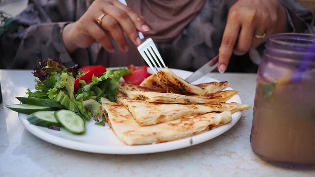 Enjoying a meal of paratha with salad at a cafe