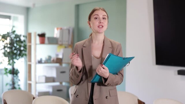 Young woman secretary with a folder with documents in her hands invites students and office workers to a training to get additional education. University has opened a set of applicants for study