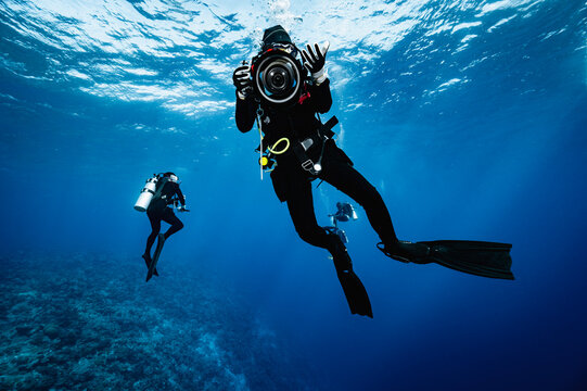Scuba diver aiming camera at the viewer