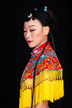 Traditional Chinese opera embroidery women in formal attire against a black background