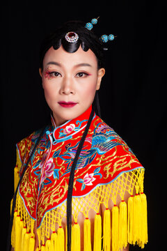 Traditional Chinese opera embroidery women in formal attire against a black background