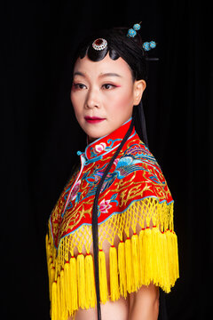 Traditional Chinese opera embroidery women in formal attire against a black background