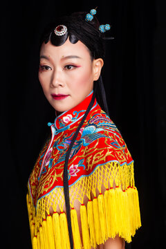 Traditional Chinese opera embroidery women in formal attire against a black background