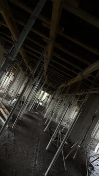 Construction progress of a modern concrete building. Reinforced concrete structure under development, showing structural framework and ongoing construction work.