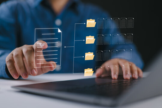 Document classification and file organization. Corporate analyst using a laptop and folders. Digital archive management, automated sorting, workflow efficiency, data categorization, document control