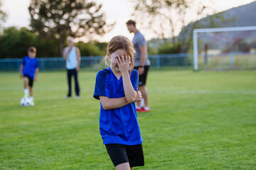 Fototapeta premium Disappointed young soccer player crying after difficult moment during football match.