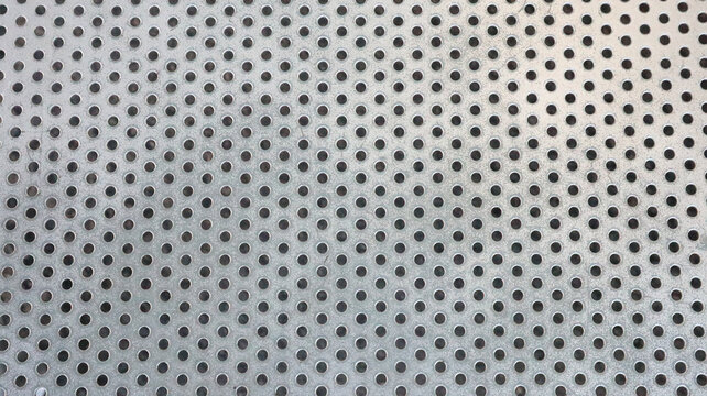 Macro shot of silver perforated metal sheet texture