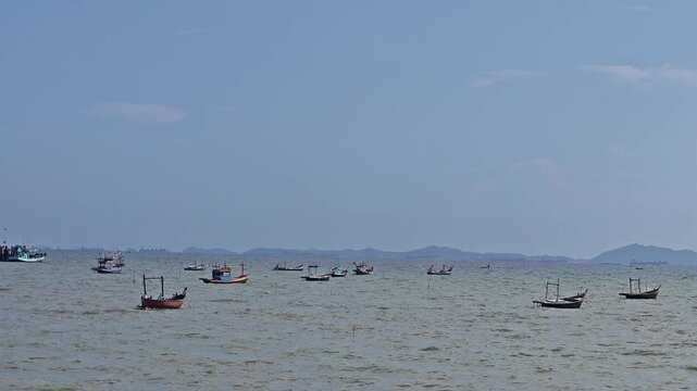 A small fishing boat is moored at the shore