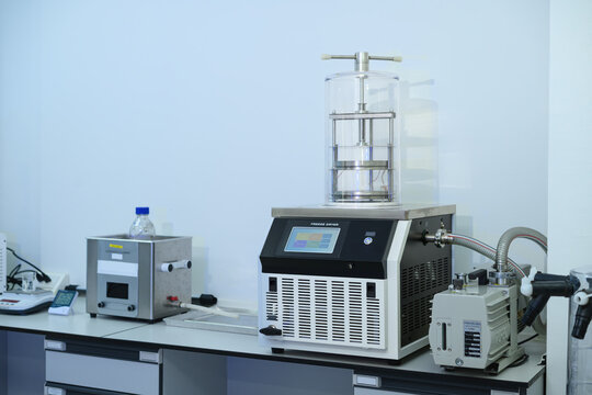 Laboratory Freeze Dryer Machine with Vacuum Pump on Lab Bench for Scientific Research and Pharmaceutical Processing