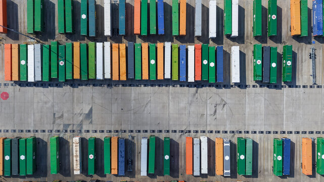 Mesquite, Texas, United States - 18 November 2025: Aerial view of rows of colorful shipping containers in a logistics yard, showcasing industrial infrastructure and geometric patterns.