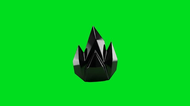 A sharp obsidian crystal formation isolated against a vibrant green screen