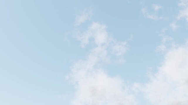 Gentle white clouds moving across a blue sky. Looped animation
