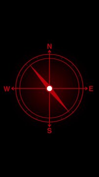 Glowing red compass rose displays cardinal direction letters over black background canvas Digital navigation interfaces show this compass rose Compass rose glows clear
