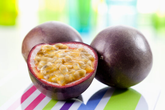 Passion fruits on chopping board, close up