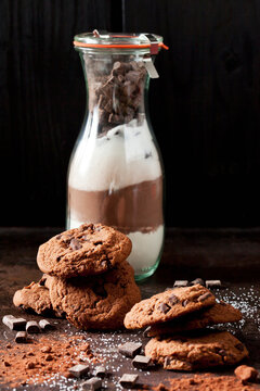 Chocolate cookies and glass bottle of baking mix