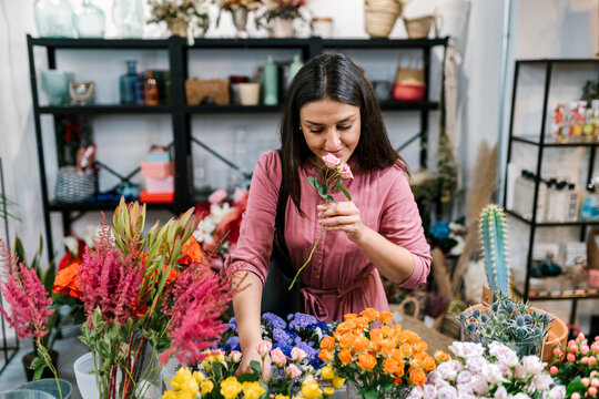 Female customer choosing flowers at shop