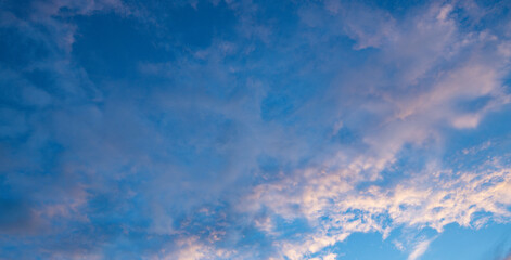 Soft clouds drift across a serene twilight sky © Sergei