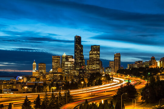 USA, Washington State, Seattle, Dr. Jose Rizal Park, Interstate 5 and skyline at blue hour