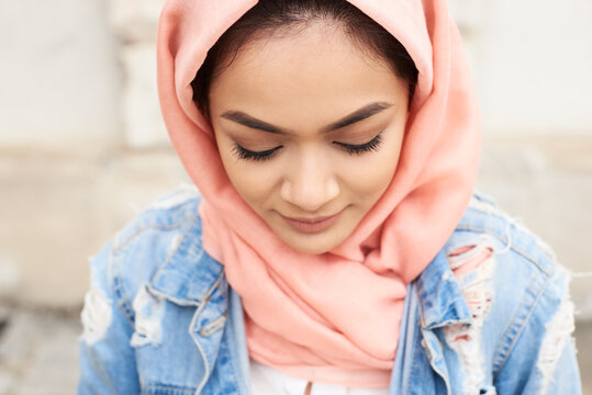 Close-up of young woman wearing hijab looking down
