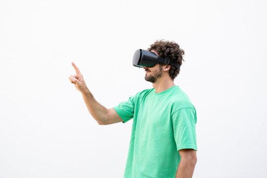 Man wears virtual reality headset and points at the copy space